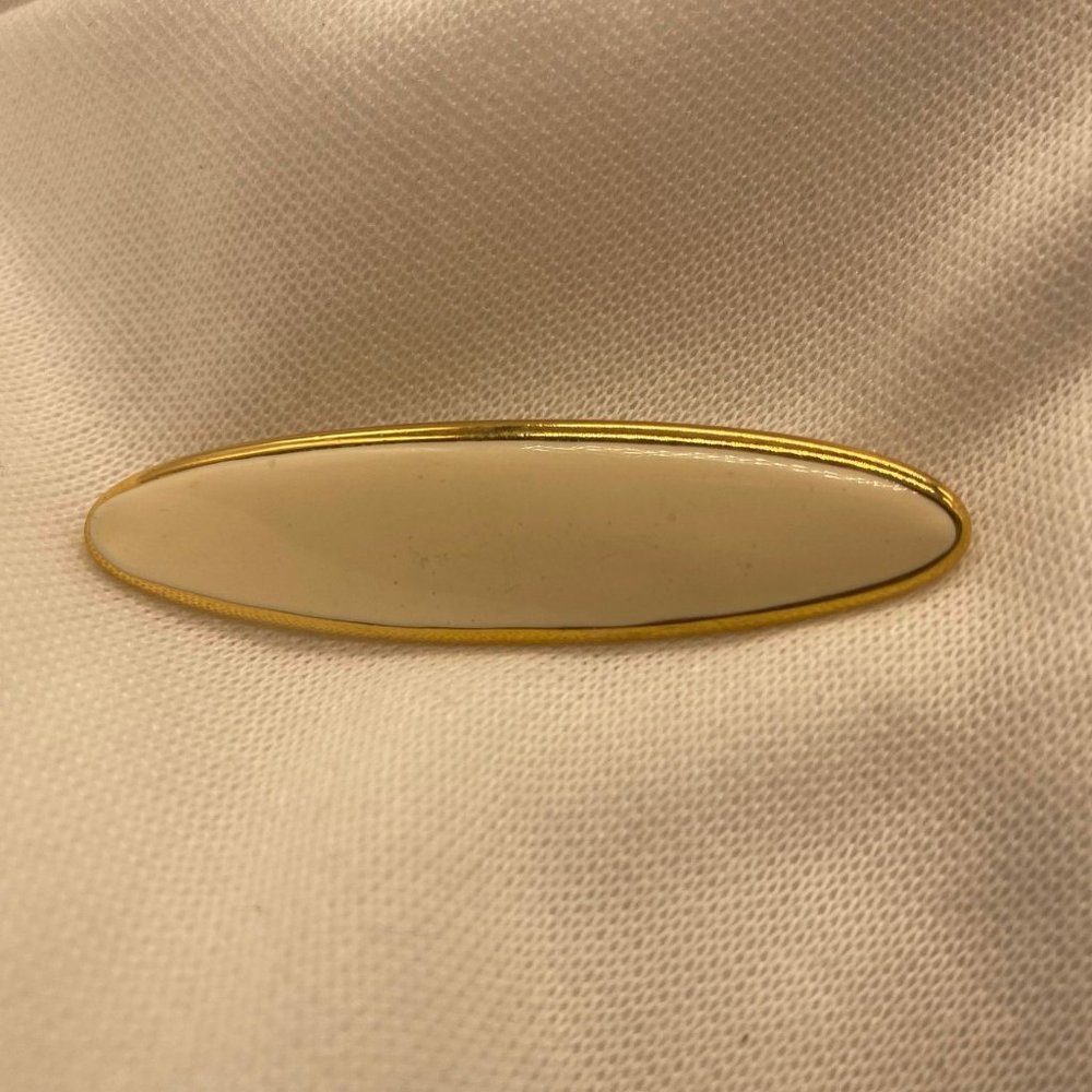 Vintage Monet cream enamel oval bar brooch in gold tone metal